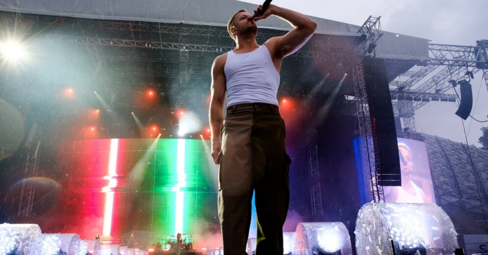 Photo: Rain does not interfere with celebrating life.  Imagine Dragons gather in Mežaparks